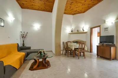 a living room with a couch and a table at Sofia Traditional House in Afantou