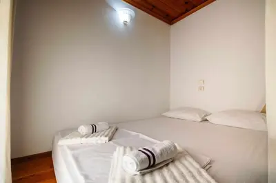 a bedroom with a bed with two towels on it at Sofia Traditional House in Afantou