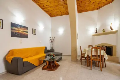 a living room with a couch and a table at Sofia Traditional House in Afantou