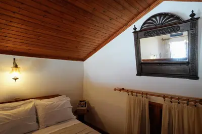 a bedroom with a bed and a mirror on the wall at Amorosa House in Symi