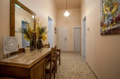 a dining room with a table with chairs and flowers at Thelia Rhodian Traditional house in Rhodes Town