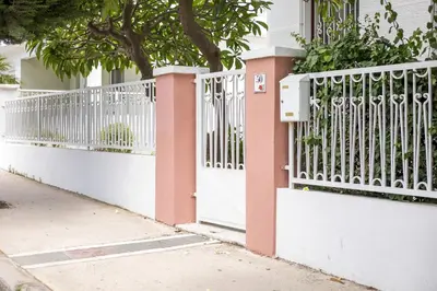 a white and pink gate in front of a house at Thelia Rhodian Traditional house in Rhodes Town