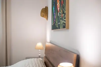 a bedroom with a bed with a lamp and a picture at Thelia Rhodian Traditional house in Rhodes Town