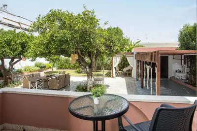 a patio with a table and chairs on a balcony at Thelia Rhodian Traditional house in Rhodes Town