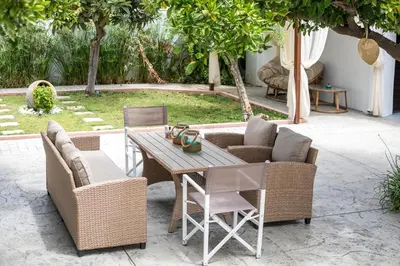a patio with a wooden table and chairs at Thelia Rhodian Traditional house in Rhodes Town