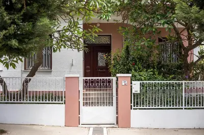 a white gate in front of a house at Thelia Rhodian Traditional house in Rhodes Town