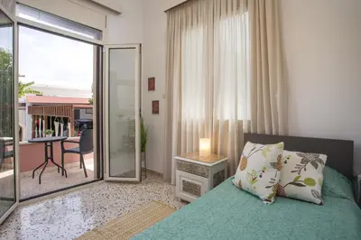 a bedroom with a bed and a view of a balcony at Thelia Rhodian Traditional house in Rhodes Town