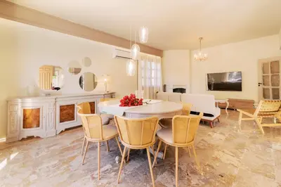 a dining room with a table and chairs and a fireplace at Costa-Aria House in Ixia