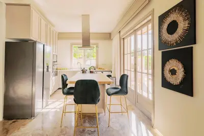 a kitchen with a dining room table and chairs at Costa-Aria House in Ixia