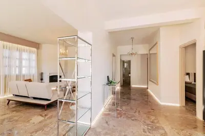 a living room with a glass bookcase and a couch at Costa-Aria House in Ixia