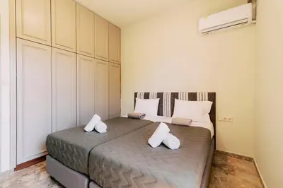 a bedroom with two beds with white pillows at Costa-Aria House in Ixia