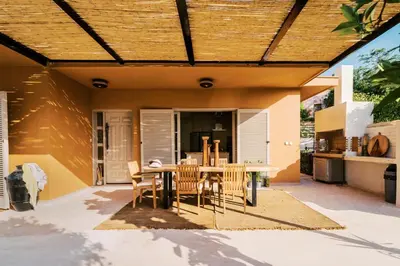 an outdoor patio with a table and chairs at Costa-Aria House in Ixia