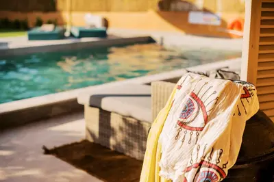 a plastic bag sitting next to a swimming pool at Costa-Aria House in Ixia