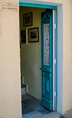a blue door to a building with pictures on the wall at Symi Central Point in Symi