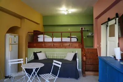 a bedroom with a bunk bed and a table at Symi Central Point in Symi