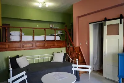 a bedroom with a bunk bed and a staircase at Symi Central Point in Symi