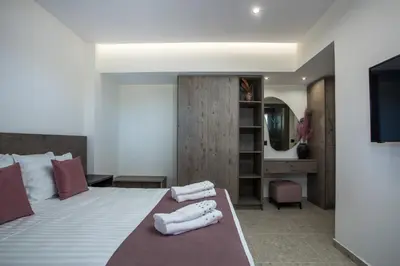 a bedroom with a bed with towels on it at Matsi Suites in Faliraki