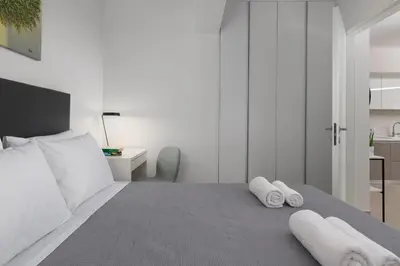 a bedroom with a bed with towels on it at Aegean Escape Luxury Apartment in Rhodes Town