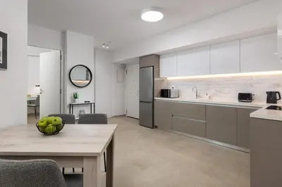 a kitchen with a table with a bowl of fruit on it at Aegean Escape Luxury Apartment in Rhodes Town