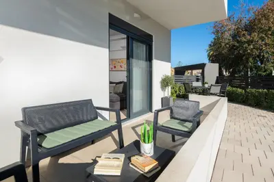 two chairs and a table on a patio at Aegean Escape Luxury Apartment in Rhodes Town