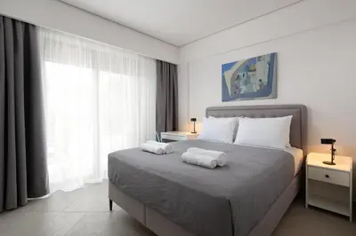 a bedroom with a bed with two towels on it at Aegean Escape Luxury Apartment in Rhodes Town