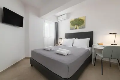 a bedroom with a bed with two towels on it at Aegean Escape Luxury Apartment in Rhodes Town