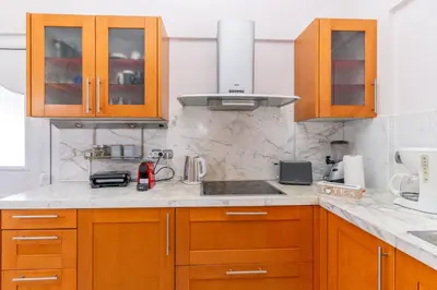 a kitchen with wooden cabinets and a sink at Casa della Pace in Ialyssos