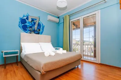 a bedroom with a bed with two stuffed animals on it at Casa della Pace in Ialyssos