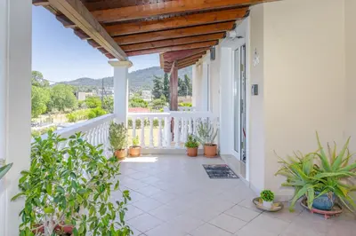 a balcony with potted plants and a wooden ceiling at Casa della Pace in Ialyssos
