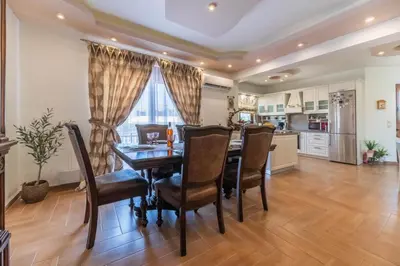 a kitchen and dining room with a table and chairs at Kira's Lovely Villa Massari in Haraki