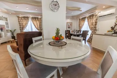 a dining room and living room with a table and chairs at Kira's Lovely Villa Massari in Haraki