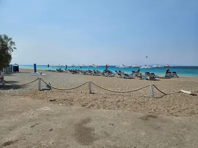a group of people sitting on a beach at Nereides Apartments Rhodes in Kremasti