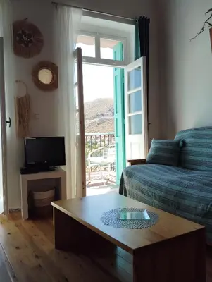 a living room with a couch and a coffee table at 89 Steps Symi in Symi