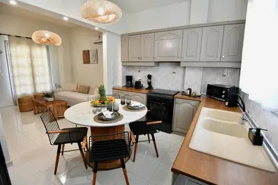 a kitchen and living room with a table and chairs at Melia Casa in Rhodes Town