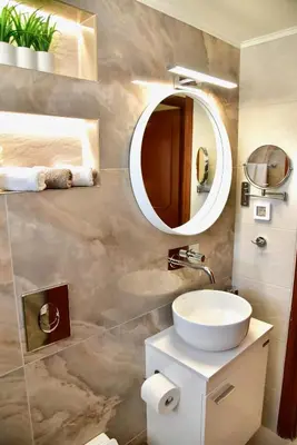 a bathroom with a sink and a mirror at Melia Casa in Rhodes Town