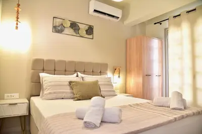 a bedroom with a large bed with white pillows at Melia Casa in Rhodes Town