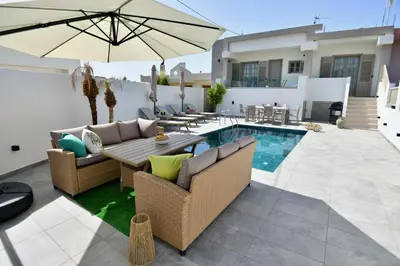 a patio with a table and chairs and an umbrella at Melia Casa in Rhodes Town