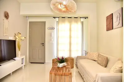 a living room with a couch and a tv at Melia Casa in Rhodes Town