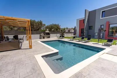 a swimming pool in the middle of a patio at Villa Pasadra in Afantou
