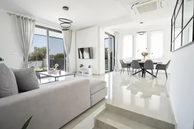 a living room with a couch and a table at Villa Pasadra in Afantou