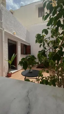 a patio with a table and some plants and a building at Isola Studio 1 in Rhodes Town