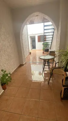 a room with a table and chairs and a patio at Isola Studio 1 in Rhodes Town