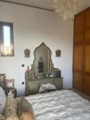 a bedroom with a bed and a mirror on the wall at Villa Eleni-Gennadi in Yennadhion