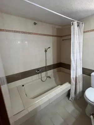 a bathroom with a bath tub and a toilet at Villa Eleni-Gennadi in Yennadhion