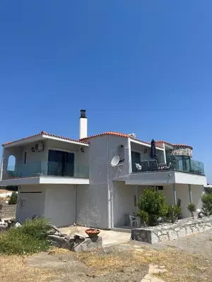 a large white house with a balcony at Villa Eleni-Gennadi in Yennadhion