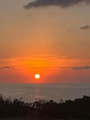 a sunset over the ocean with the sun in the sky at Villa Eleni-Gennadi in Yennadhion