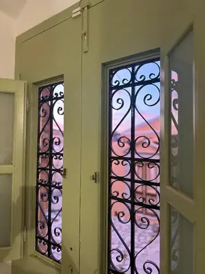 two stained glass windows in a room at Stone Steps Studio in Symi