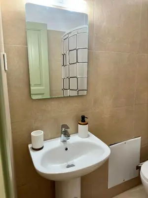 a bathroom with a sink and a mirror at Stone Steps Studio in Symi