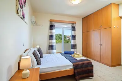 a bedroom with a large bed with a window at Villa Victoria in Afantou