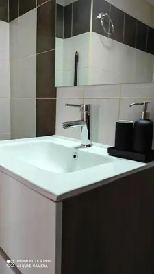 a bathroom with a white sink and a mirror at M&K house in Rhodes Town